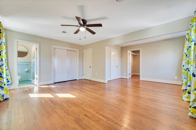 unfurnished bedroom featuring visible vents, light wood-type flooring, and baseboards