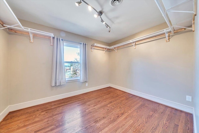 spacious closet with wood finished floors