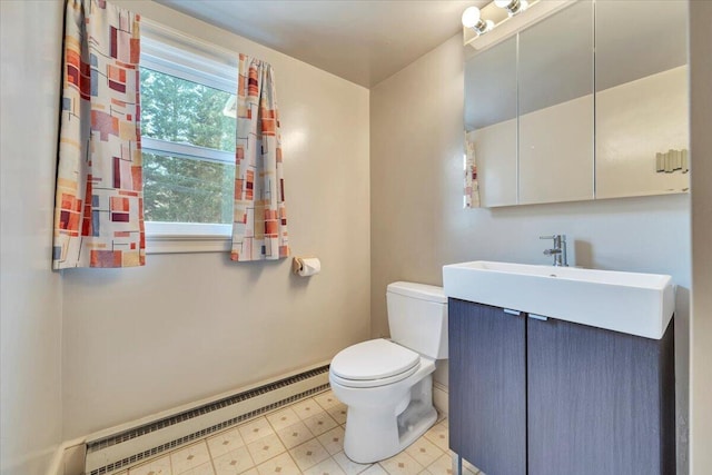 half bathroom featuring a baseboard heating unit, tile patterned floors, toilet, and vanity