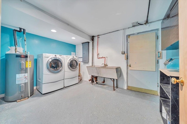 washroom featuring laundry area, electric panel, water heater, a sink, and washer and dryer