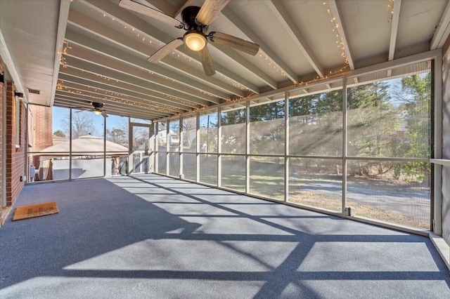 unfurnished sunroom with ceiling fan