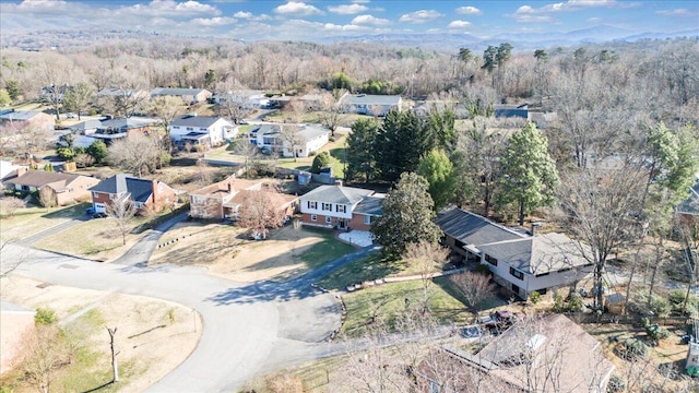 birds eye view of property with a wooded view and a residential view