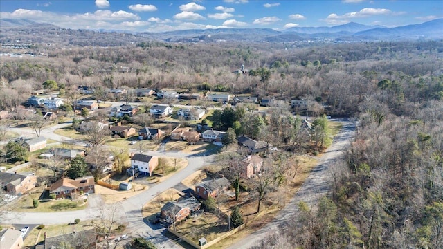 birds eye view of property featuring a mountain view and a wooded view