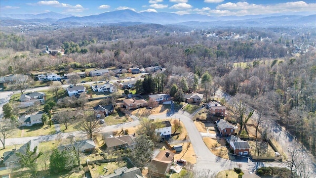 birds eye view of property featuring a forest view, a mountain view, and a residential view