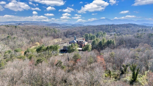 drone / aerial view with a mountain view and a wooded view