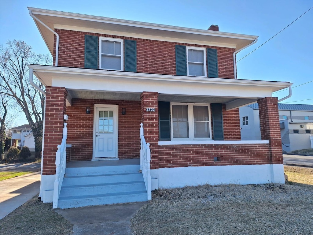 traditional style home with brick siding and a porch