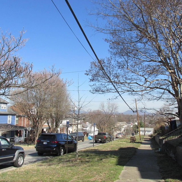 view of road with sidewalks and a residential view