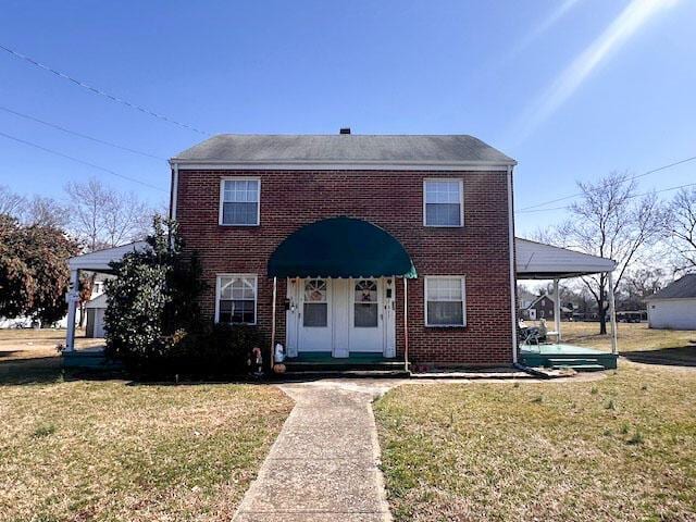 view of front facade featuring brick siding and a front yard