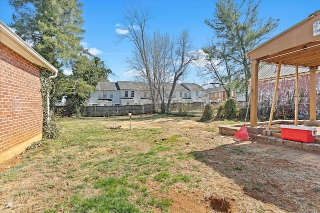 view of yard featuring fence and a residential view