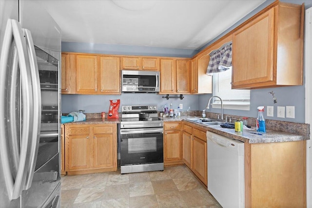 kitchen featuring stainless steel appliances, light countertops, and a sink