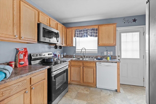 kitchen featuring appliances with stainless steel finishes and a sink