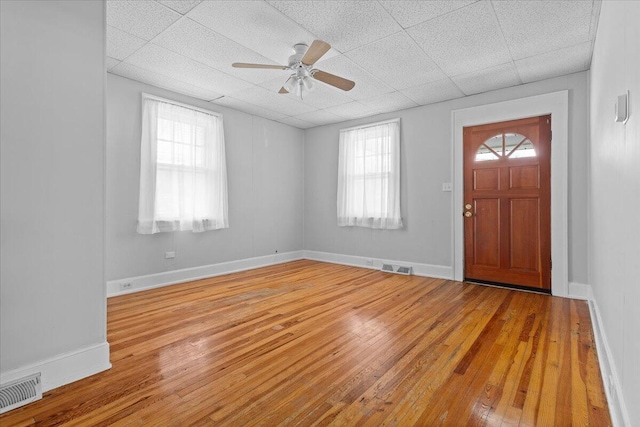 foyer with visible vents, a paneled ceiling, and hardwood / wood-style floors