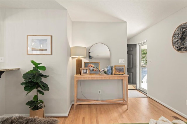 foyer entrance with baseboards and light wood-style floors