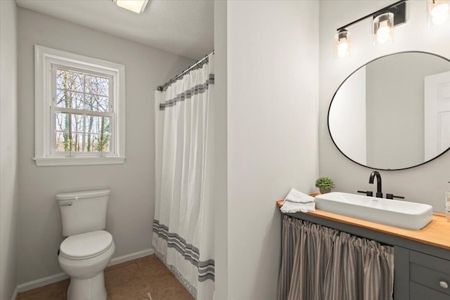 bathroom with vanity, a shower with curtain, baseboards, tile patterned floors, and toilet