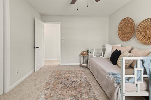 carpeted bedroom featuring baseboards and ceiling fan