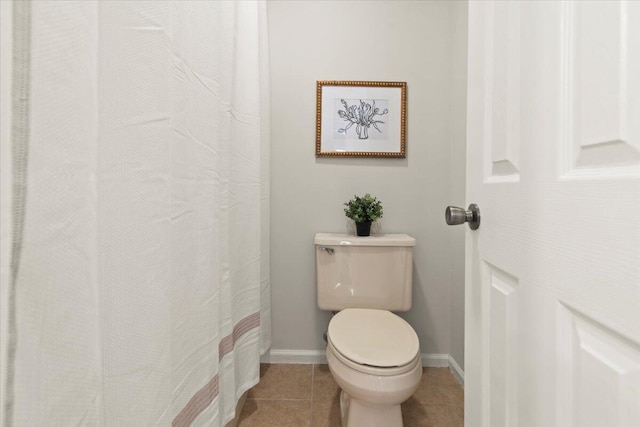 full bathroom with tile patterned flooring, toilet, and baseboards