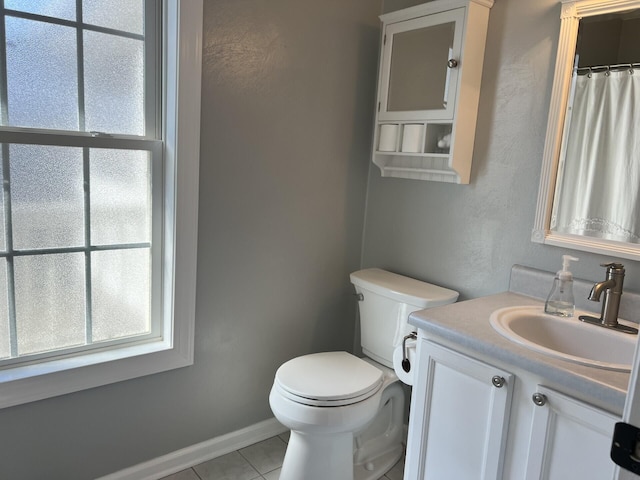 bathroom with toilet, a shower with shower curtain, tile patterned flooring, baseboards, and vanity