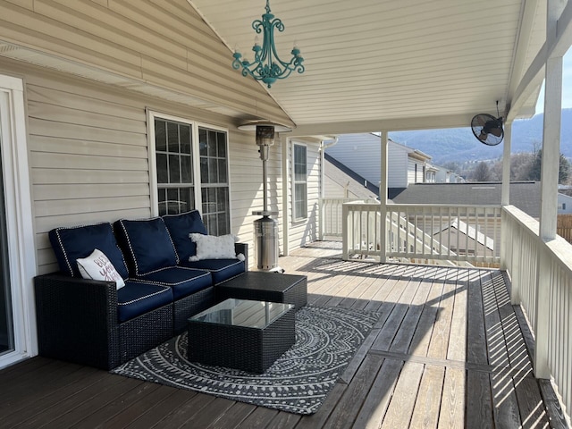 wooden terrace with a mountain view and an outdoor hangout area