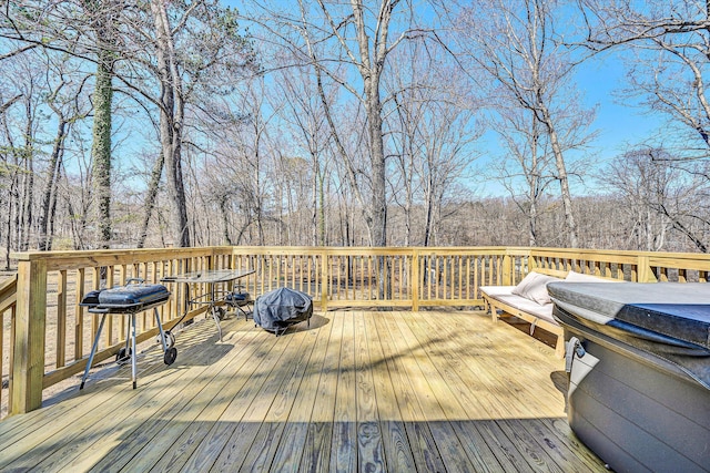 wooden deck featuring a forest view