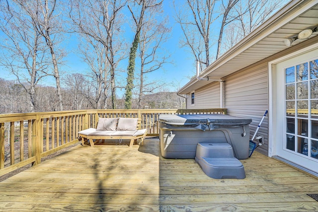 wooden deck with a hot tub