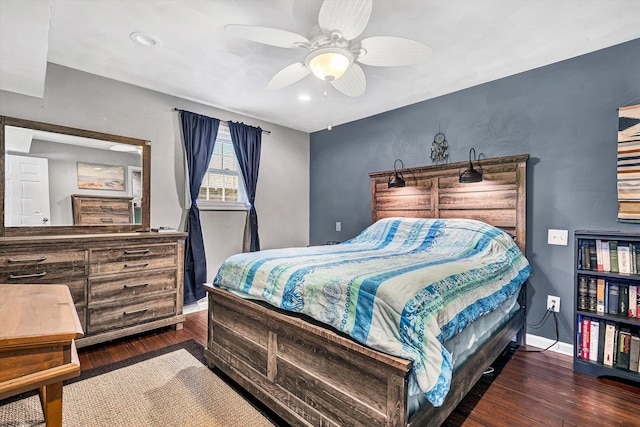 bedroom with ceiling fan, baseboards, and wood finished floors