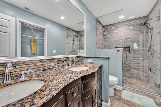 bathroom with a sink, visible vents, and a stall shower