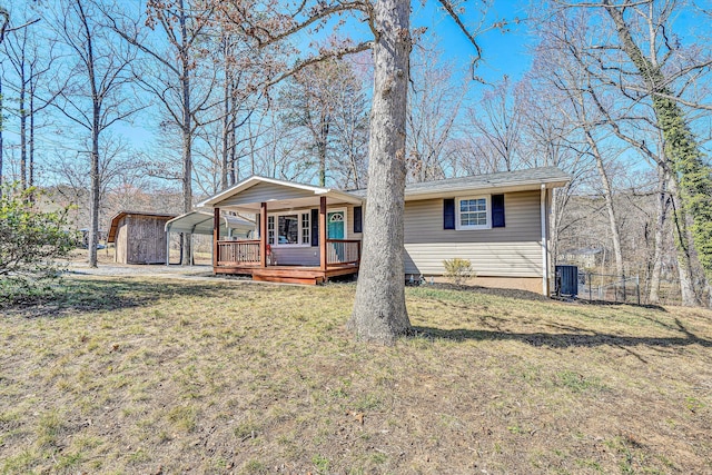 single story home featuring a detached carport, central AC, and a front yard