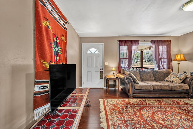 living room with baseboards and wood finished floors