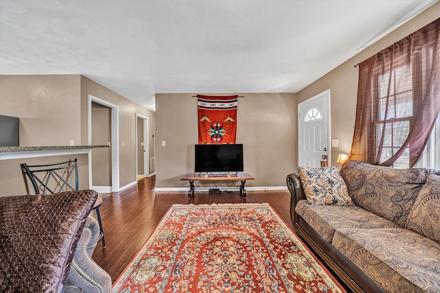 living room featuring wood finished floors and baseboards