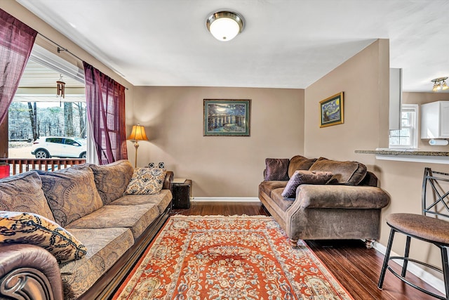 living area with dark wood-style floors and baseboards