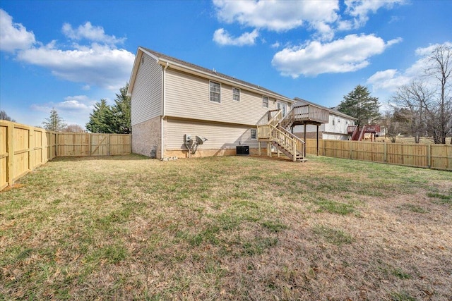 back of house with a fenced backyard, a yard, cooling unit, a wooden deck, and stairs