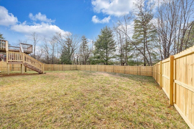 view of yard featuring stairs and a fenced backyard