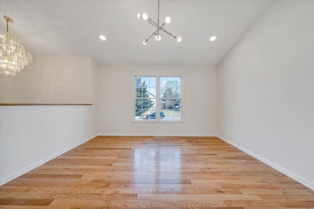 unfurnished room featuring recessed lighting, wood finished floors, baseboards, and a chandelier