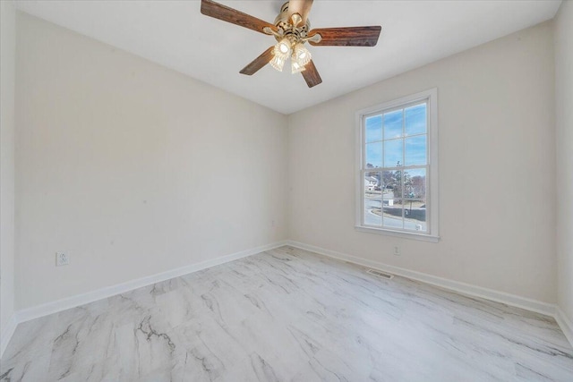 empty room with a ceiling fan, visible vents, and baseboards