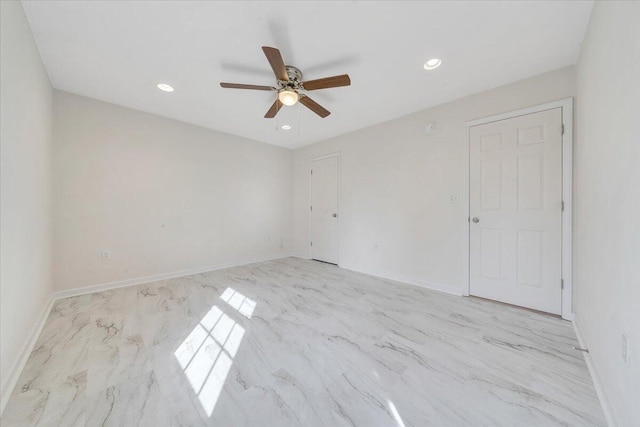 spare room with a ceiling fan, recessed lighting, and baseboards