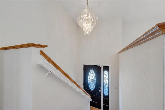 entrance foyer with stairway and a notable chandelier