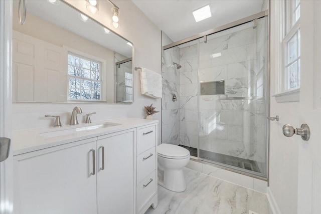 bathroom featuring a marble finish shower, toilet, marble finish floor, and vanity