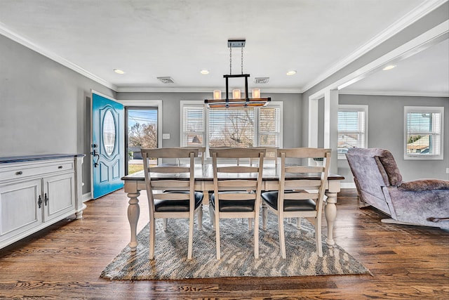 dining room featuring an inviting chandelier, dark wood finished floors, and crown molding