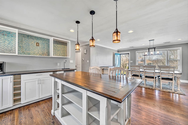 kitchen featuring open shelves, dark wood-style flooring, butcher block countertops, white cabinetry, and a wealth of natural light