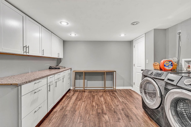 washroom with baseboards, washer and clothes dryer, dark wood finished floors, recessed lighting, and cabinet space