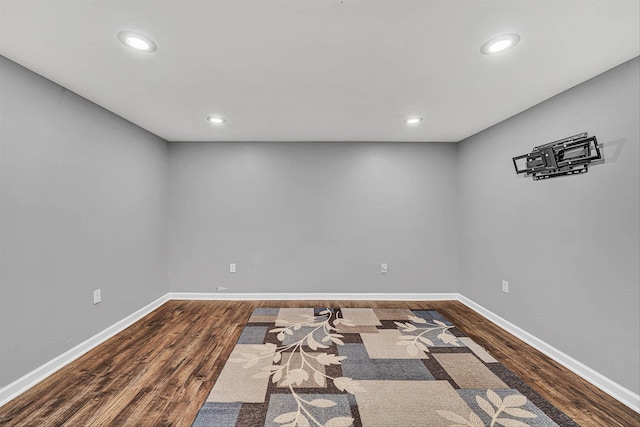 unfurnished room featuring recessed lighting, baseboards, and dark wood finished floors