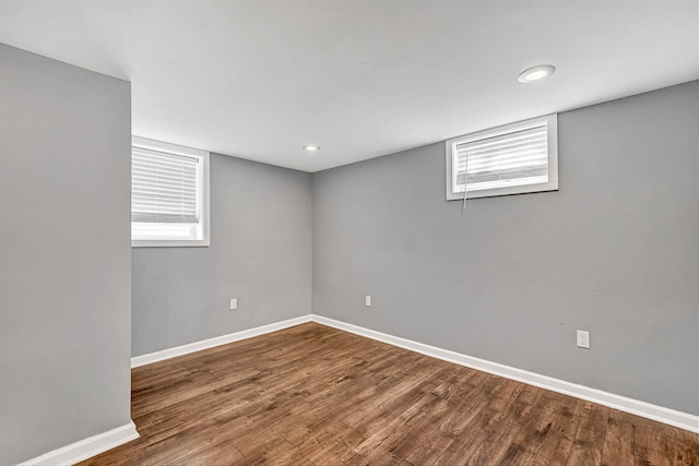 spare room featuring recessed lighting, baseboards, and wood finished floors