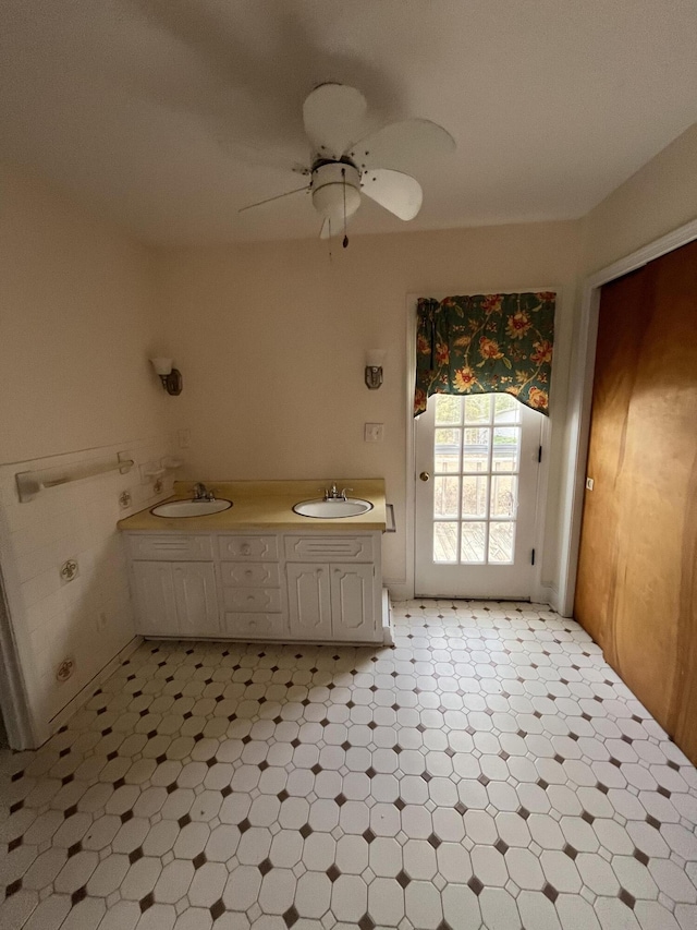 bathroom with double vanity, tile patterned floors, ceiling fan, and a sink