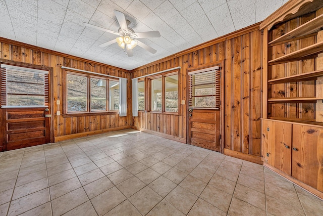 unfurnished sunroom with a ceiling fan