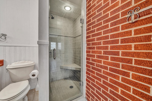 full bath featuring tile patterned floors, a shower stall, and toilet