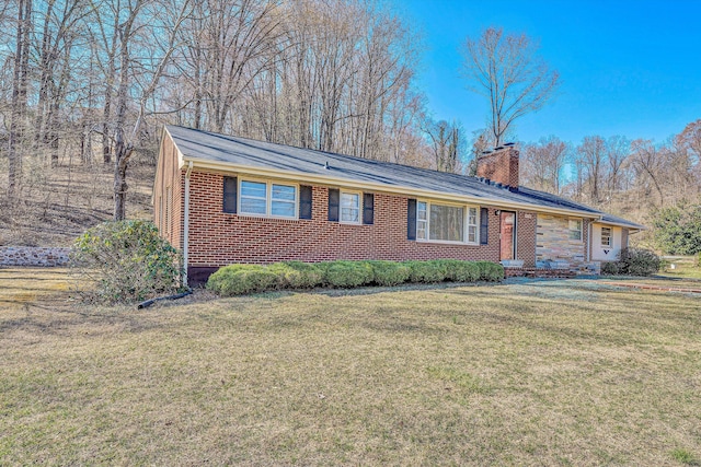 single story home with a front lawn, brick siding, and a chimney