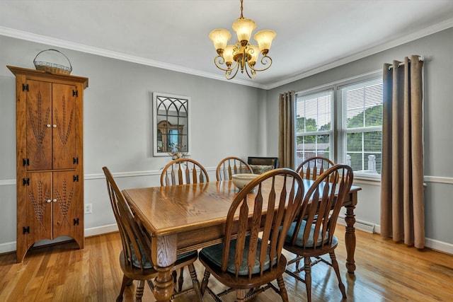 dining room featuring light wood-style flooring, baseboards, a chandelier, and ornamental molding