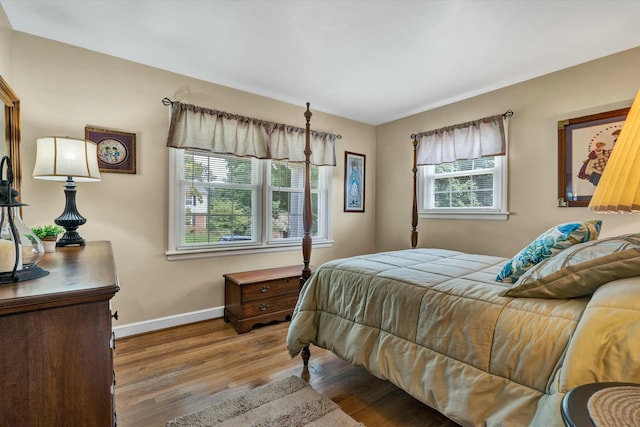 bedroom with baseboards and wood finished floors