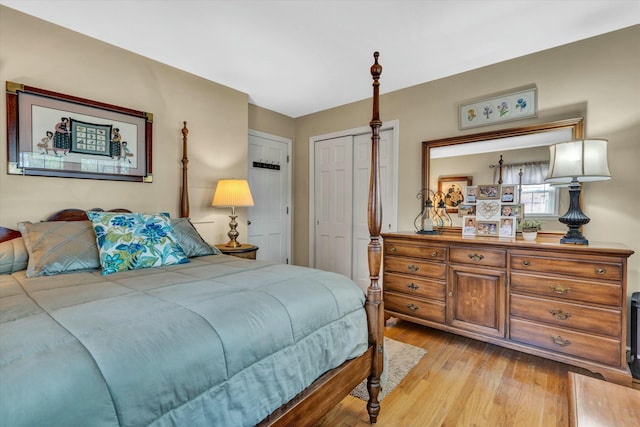 bedroom featuring light wood-style floors and a closet