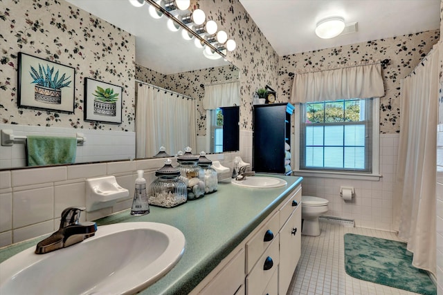 bathroom featuring tile patterned flooring, toilet, wallpapered walls, and a sink